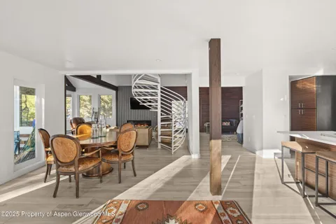 a living room with furniture a rug and a window