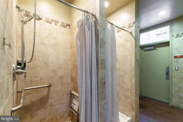 a bathroom with a shower and a glass door shower