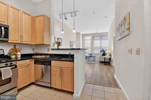 a kitchen with a sink appliances cabinets and furniture