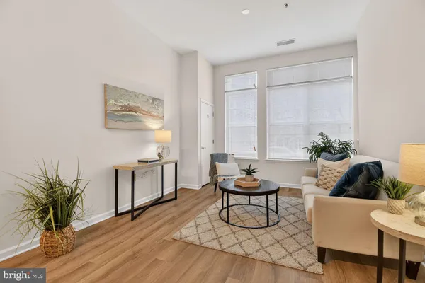 a living room with furniture and a potted plant