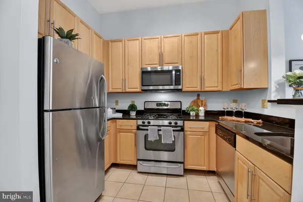 a kitchen with a refrigerator a stove a microwave and cabinets
