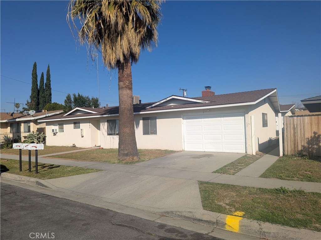 a front view of a house with yard and garage