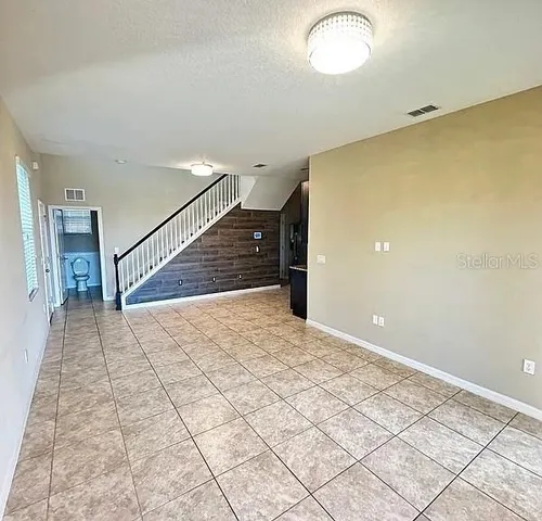 a view of a room with stairs and wooden floor