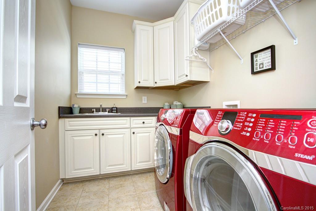 674 Reliance Court Tega Cay, SC 29708 - Photo 11 of 24 a utility room with stainless steel appliances white cabinets and a sink