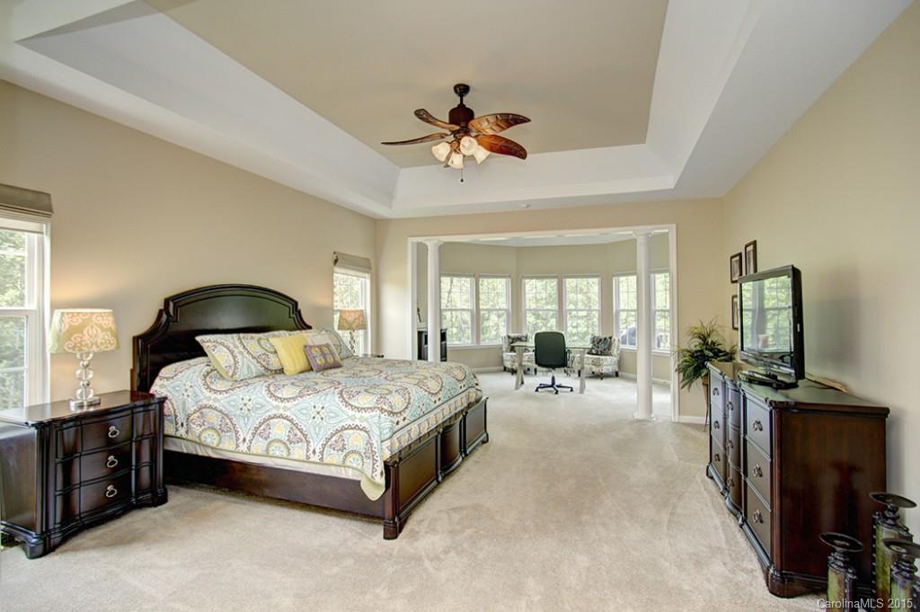 674 Reliance Court Tega Cay, SC 29708 - Photo 13 of 24 a spacious bedroom with a bed and a large window