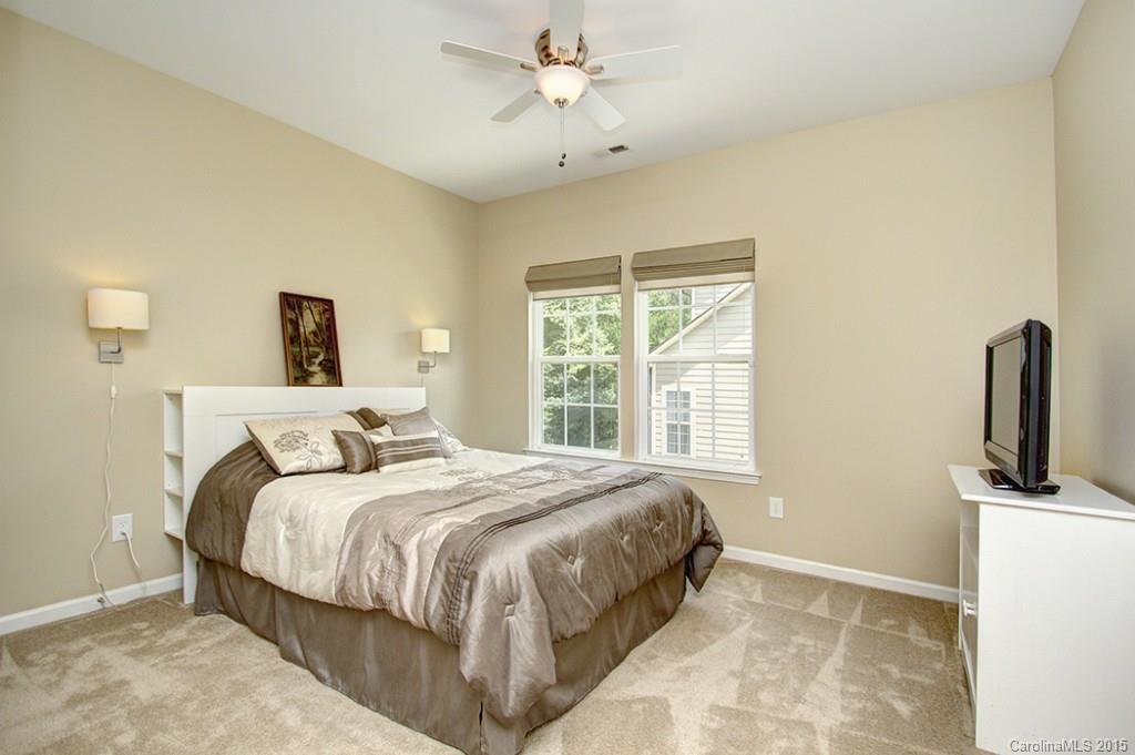 674 Reliance Court Tega Cay, SC 29708 - Photo 17 of 24 a bedroom with a bed flat screen tv and a window