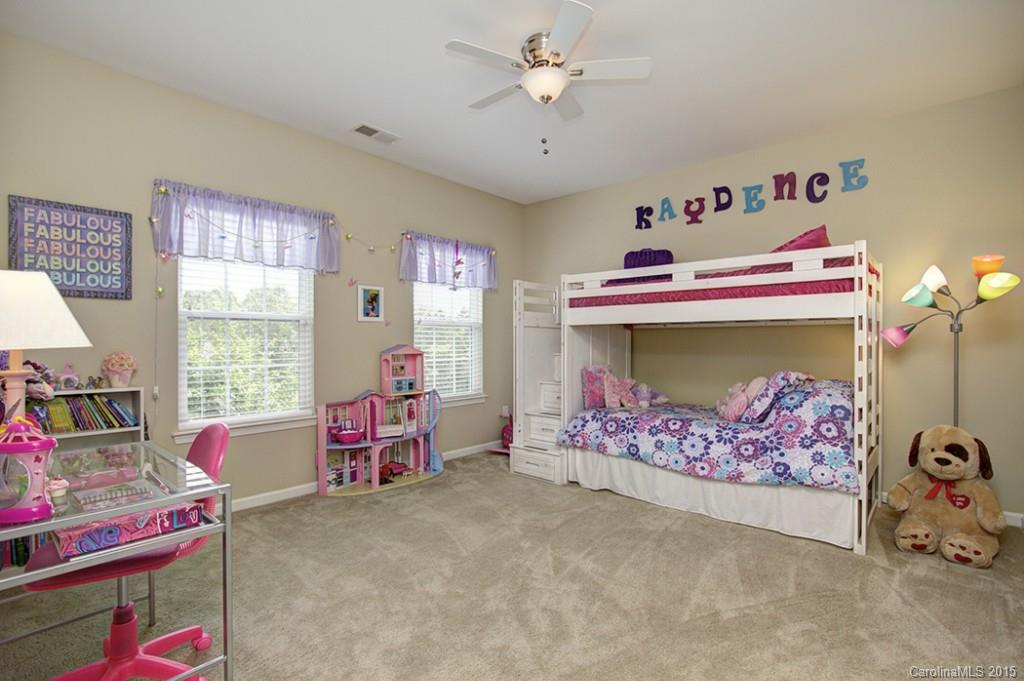 674 Reliance Court Tega Cay, SC 29708 - Photo 20 of 24 a bedroom with furniture and a chandelier fan