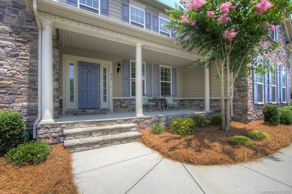 674 Reliance Court Tega Cay, SC 29708 - Photo 3 of 24 a view of a house with potted plants and a large tree