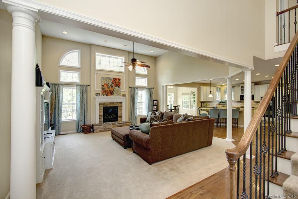 674 Reliance Court Tega Cay, SC 29708 - Photo 4 of 24 a living room with furniture large window and a fireplace