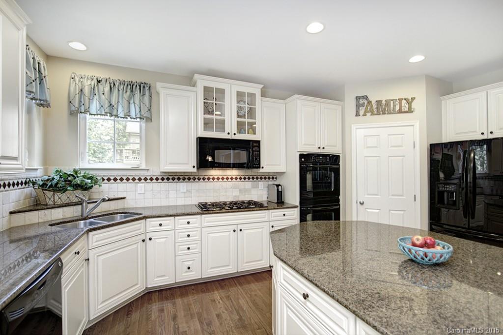 674 Reliance Court Tega Cay, SC 29708 - Photo 8 of 24 a kitchen with stainless steel appliances granite countertop a sink and cabinets