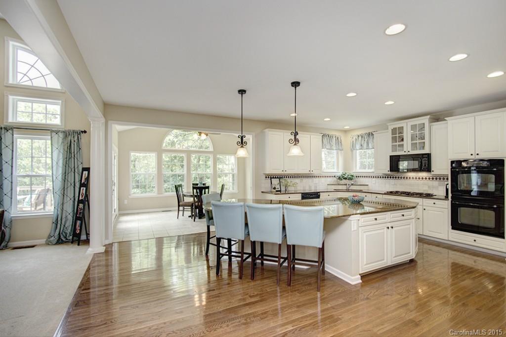 674 Reliance Court Tega Cay, SC 29708 - Photo 9 of 24 a large kitchen with a table and chairs