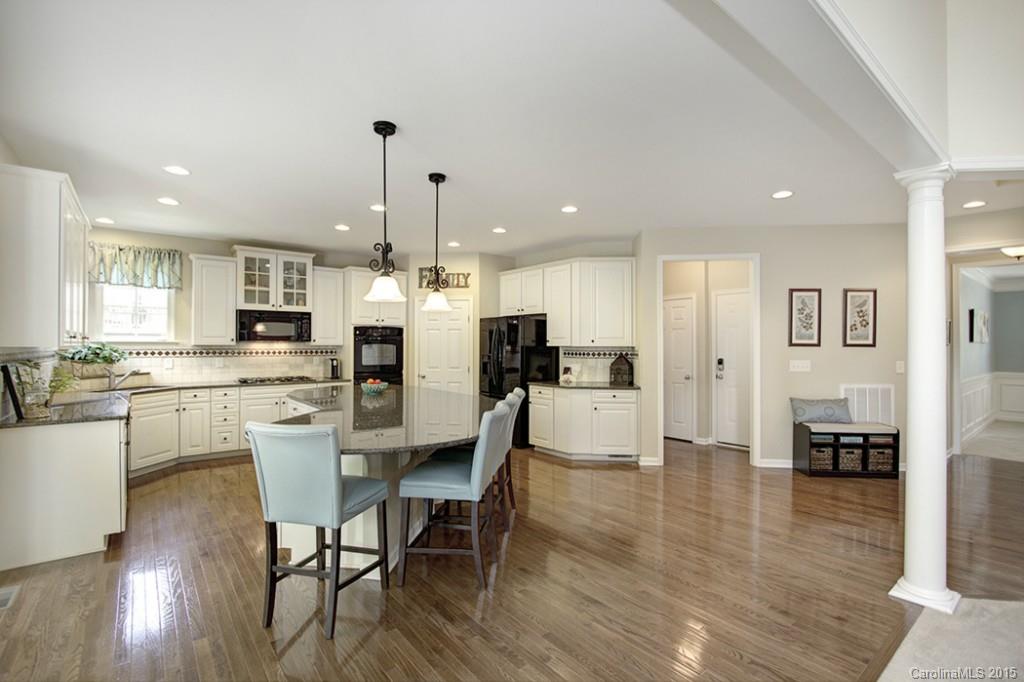 674 Reliance Court Tega Cay, SC 29708 - Photo 10 of 24 a view of a dining room kitchen with furniture and wooden floor