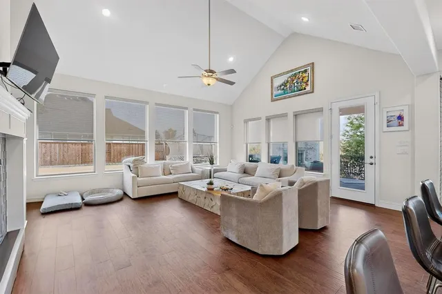 a living room with furniture kitchen view and a window