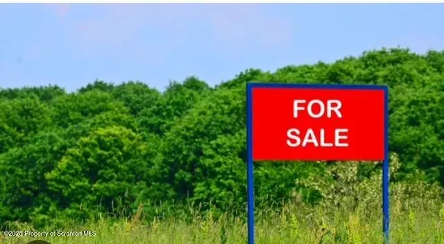 a sign that is sitting on a lush green field