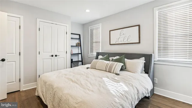 a bedroom with a bed and a mirror