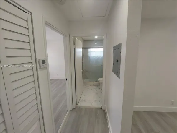 a view of empty room with wooden floor