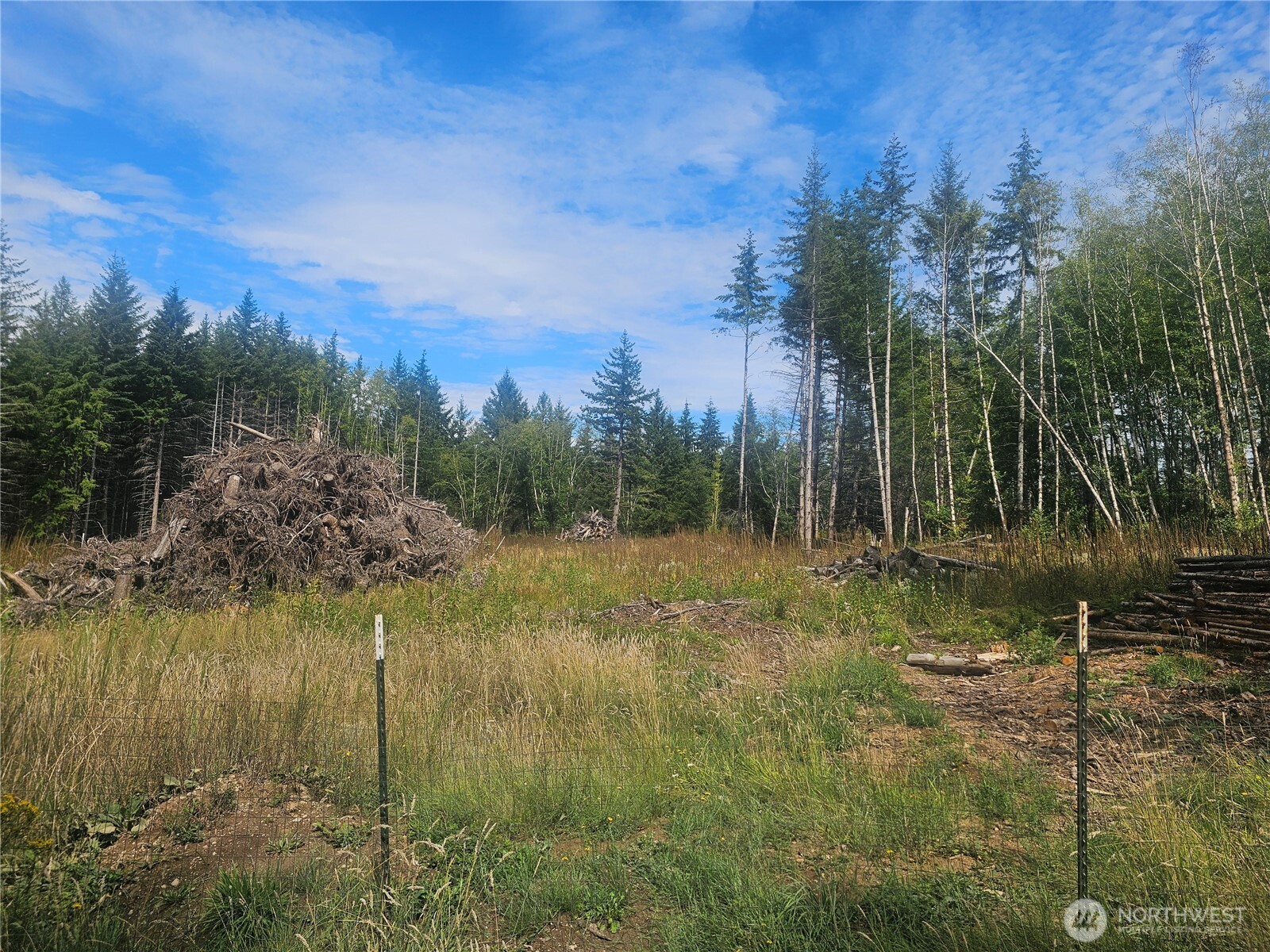 91 East Joyce Lane Belfair, WA 98528 - Photo 5 of 9 a view of a lake view with houses in background