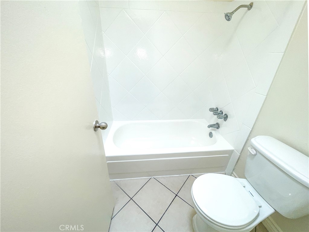 13717 Chadron Avenue, Unit 16 Hawthorne, CA 90250 - Photo 8 of 11 a white toilet sitting next to a bath tub