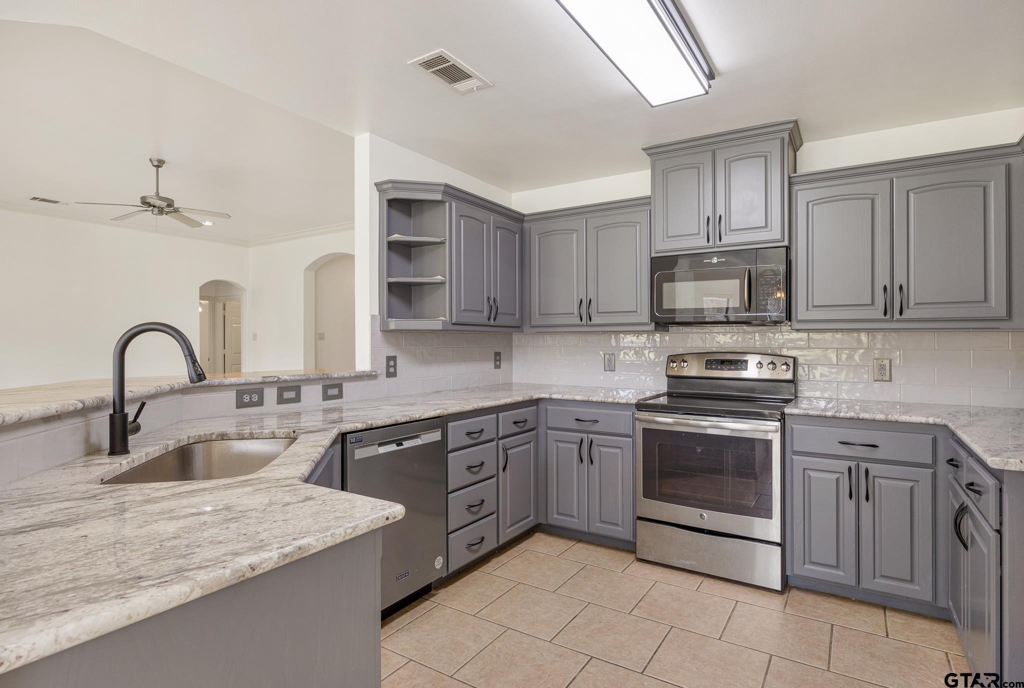 209 Cass Circle Tyler, TX 75703 - Photo 11 of 33 a kitchen with stainless steel appliances granite countertop a sink and cabinets
