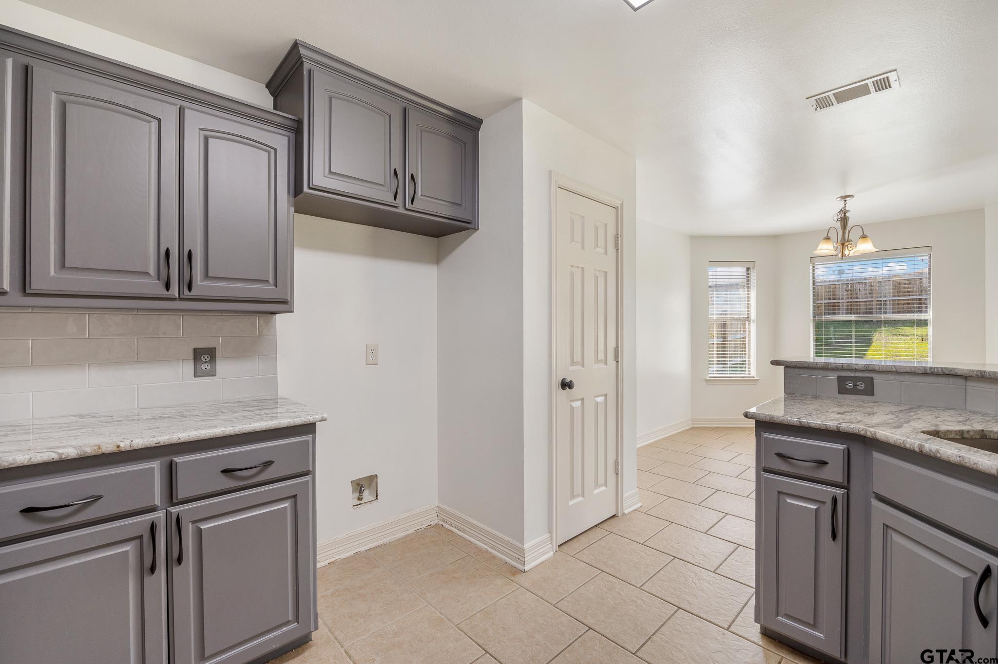 209 Cass Circle Tyler, TX 75703 - Photo 12 of 33 a kitchen with stainless steel appliances granite countertop a sink and a granite counter tops