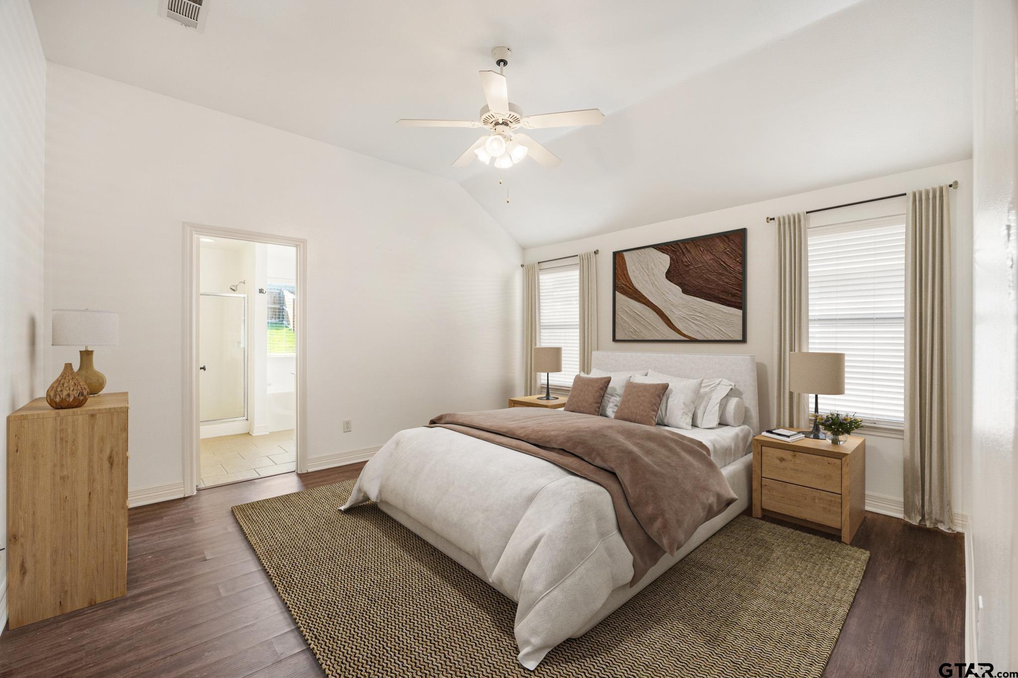 209 Cass Circle Tyler, TX 75703 - Photo 16 of 33 a bedroom with a large bed and a chandelier