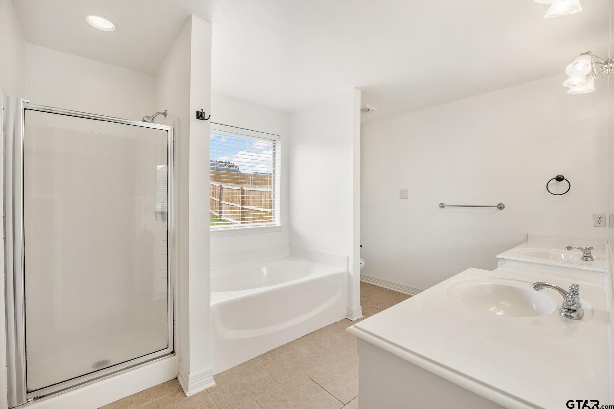 209 Cass Circle Tyler, TX 75703 - Photo 17 of 33 a bathroom with a tub and a sink
