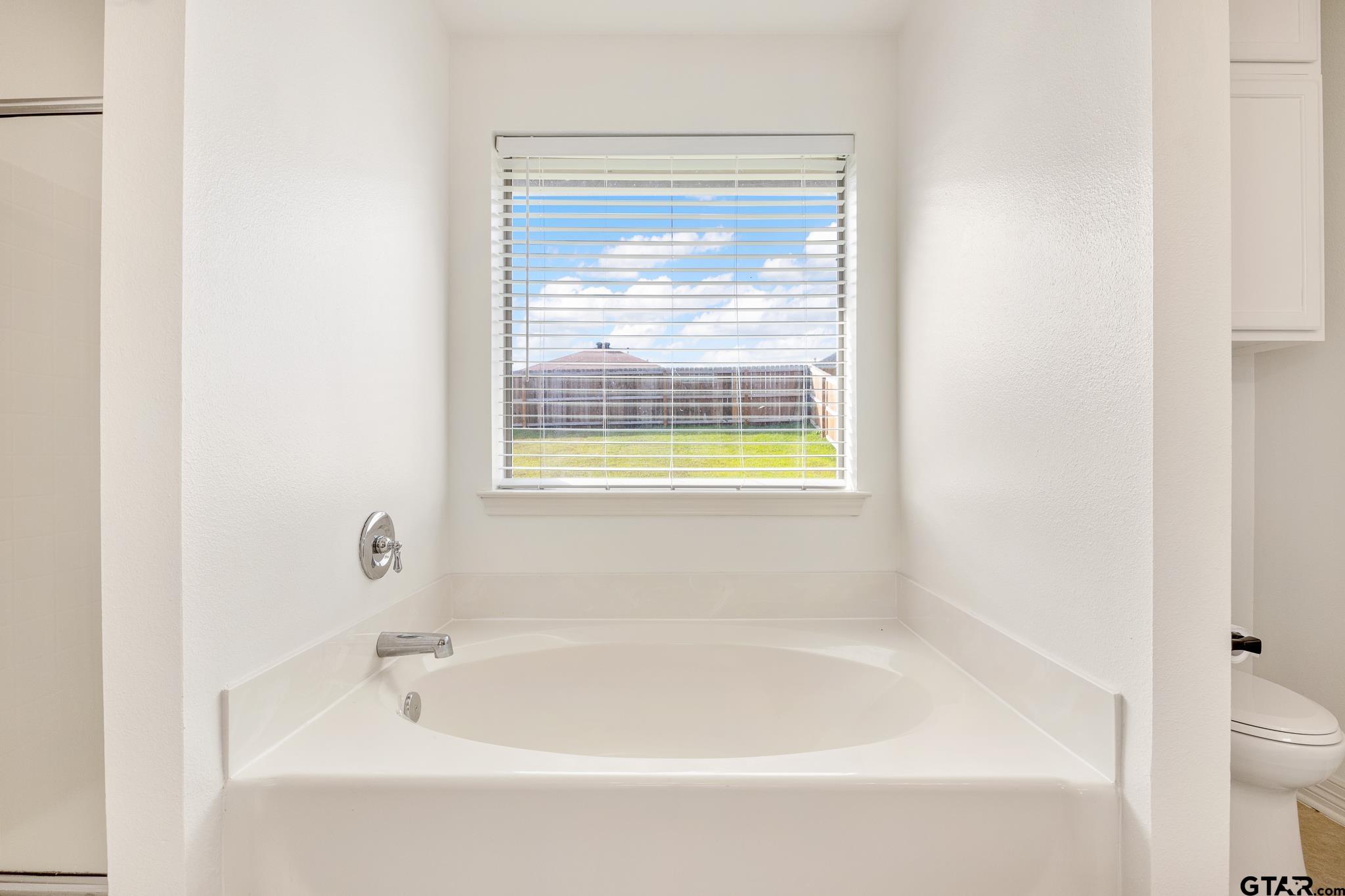 209 Cass Circle Tyler, TX 75703 - Photo 20 of 33 a white bath tub sitting next to a white sink
