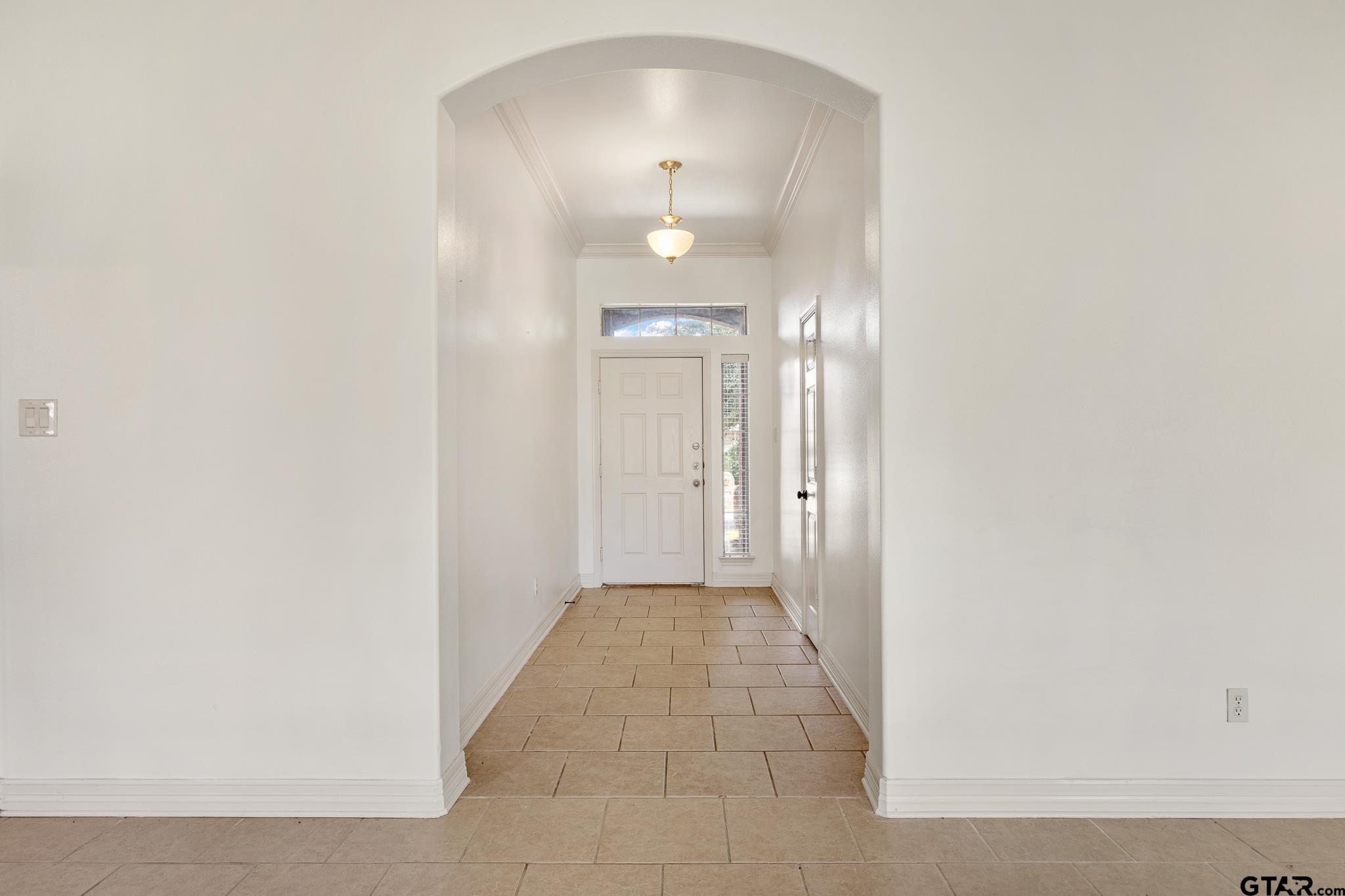 209 Cass Circle Tyler, TX 75703 - Photo 4 of 33 a view of a hallway with wooden floor and a mirror