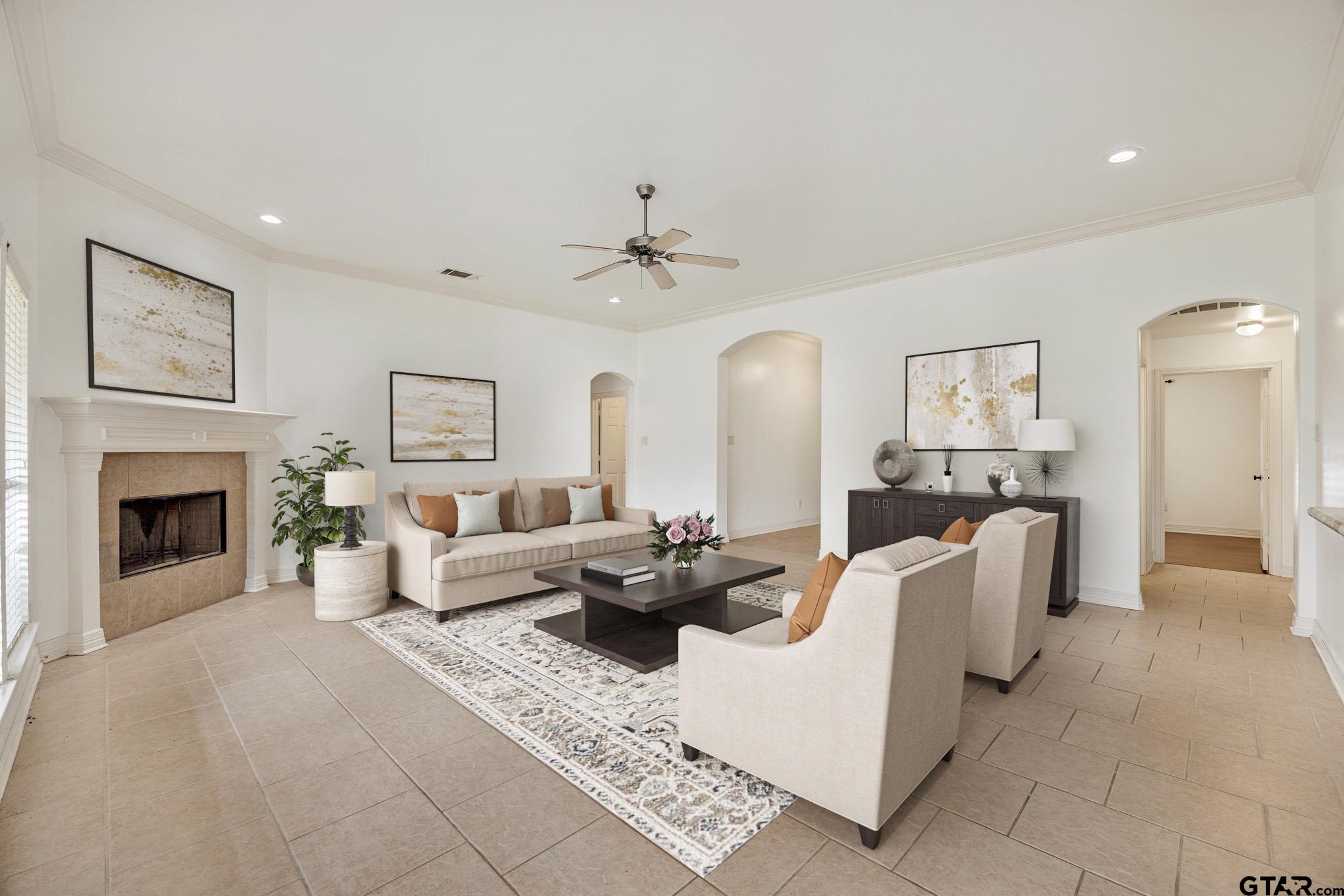 209 Cass Circle Tyler, TX 75703 - Photo 6 of 33 a living room with furniture a fireplace and a chandelier