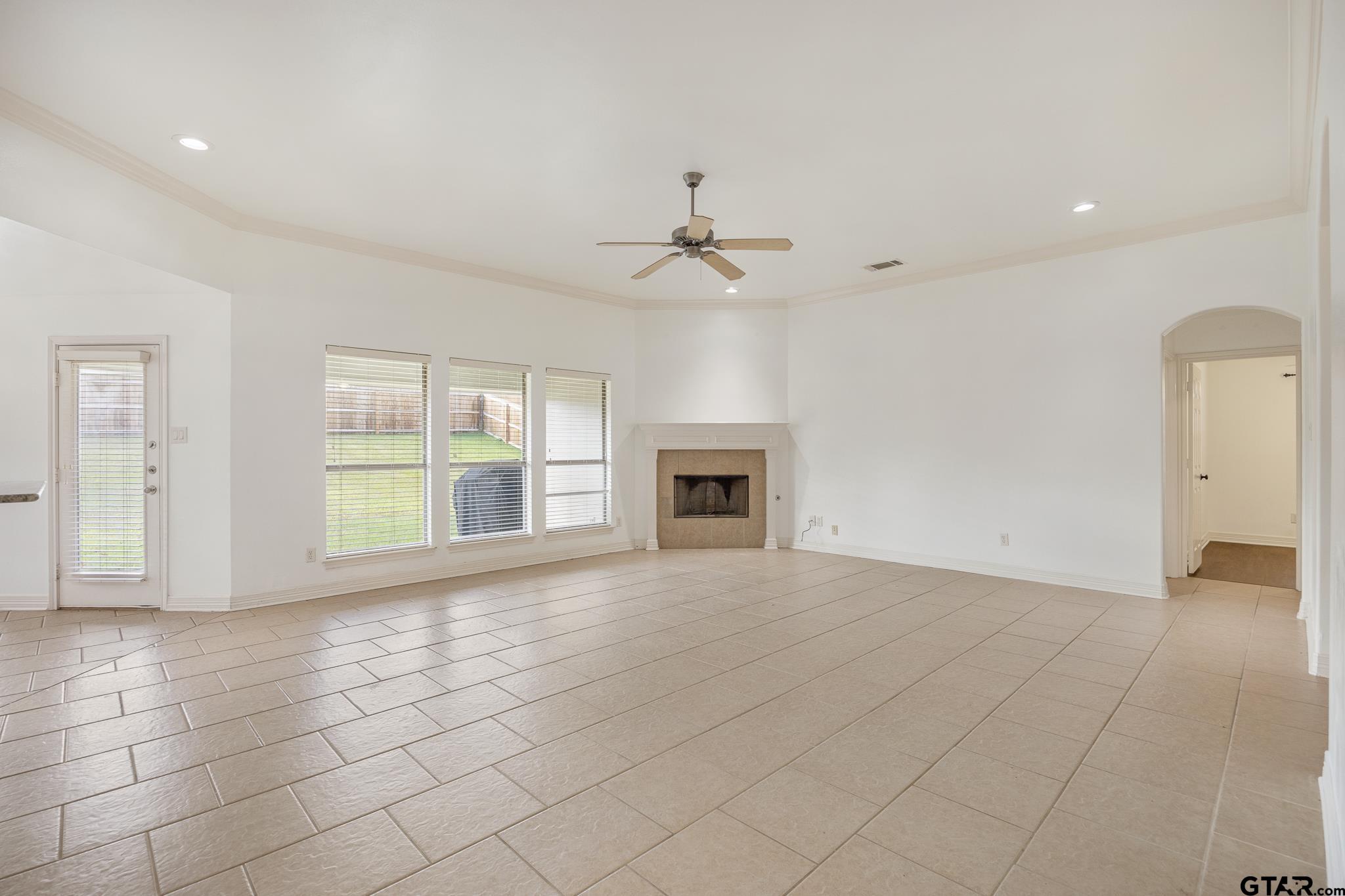 209 Cass Circle Tyler, TX 75703 - Photo 7 of 33 an empty room with windows and fireplace