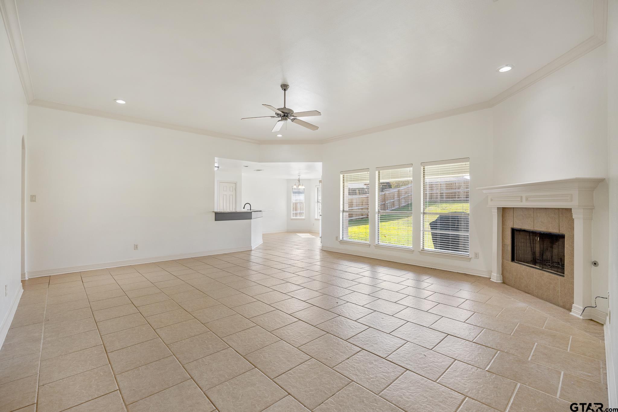 209 Cass Circle Tyler, TX 75703 - Photo 8 of 33 a view of an empty room with a fireplace and a window