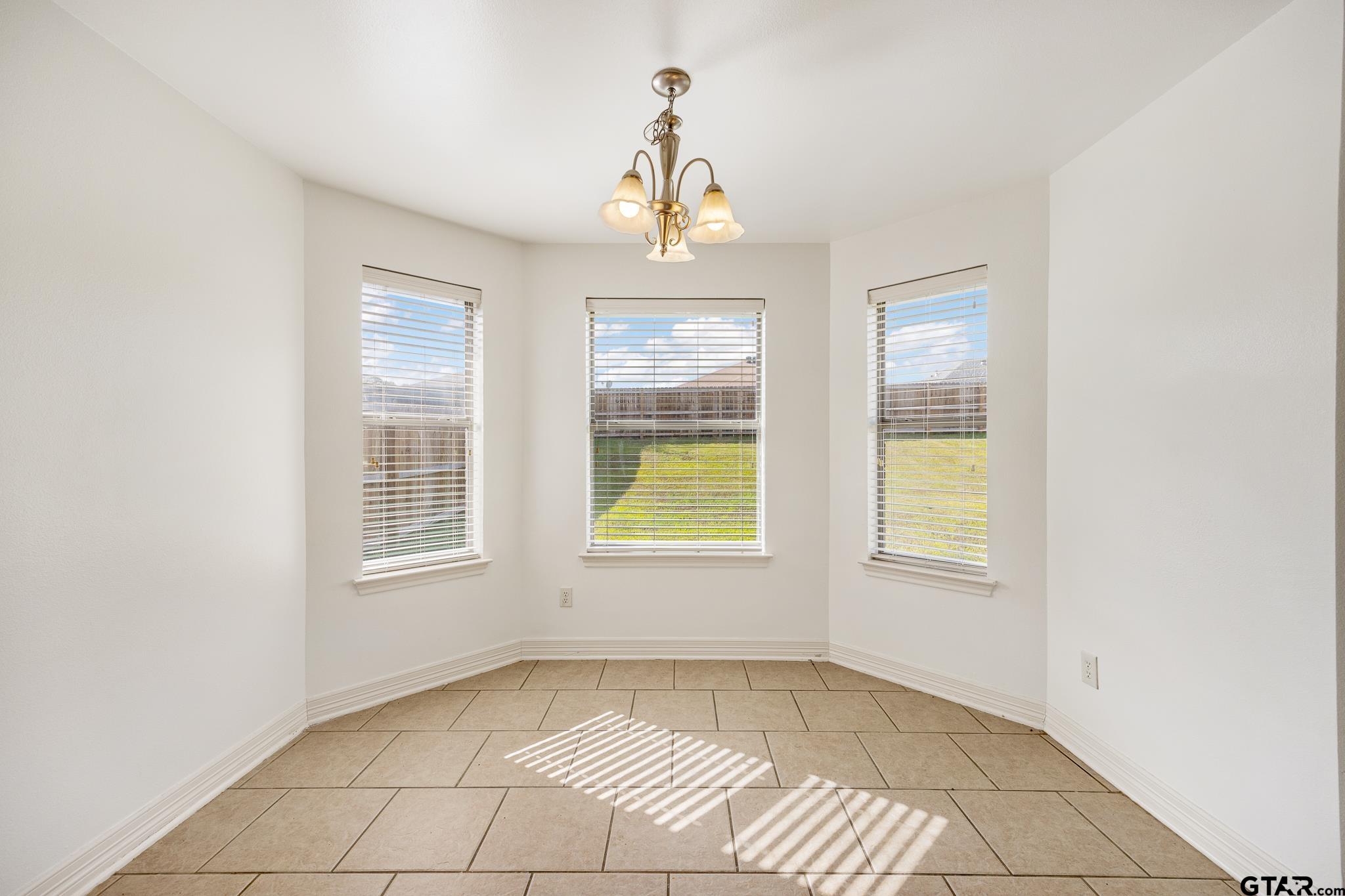 209 Cass Circle Tyler, TX 75703 - Photo 9 of 33 an empty room with windows and entrance