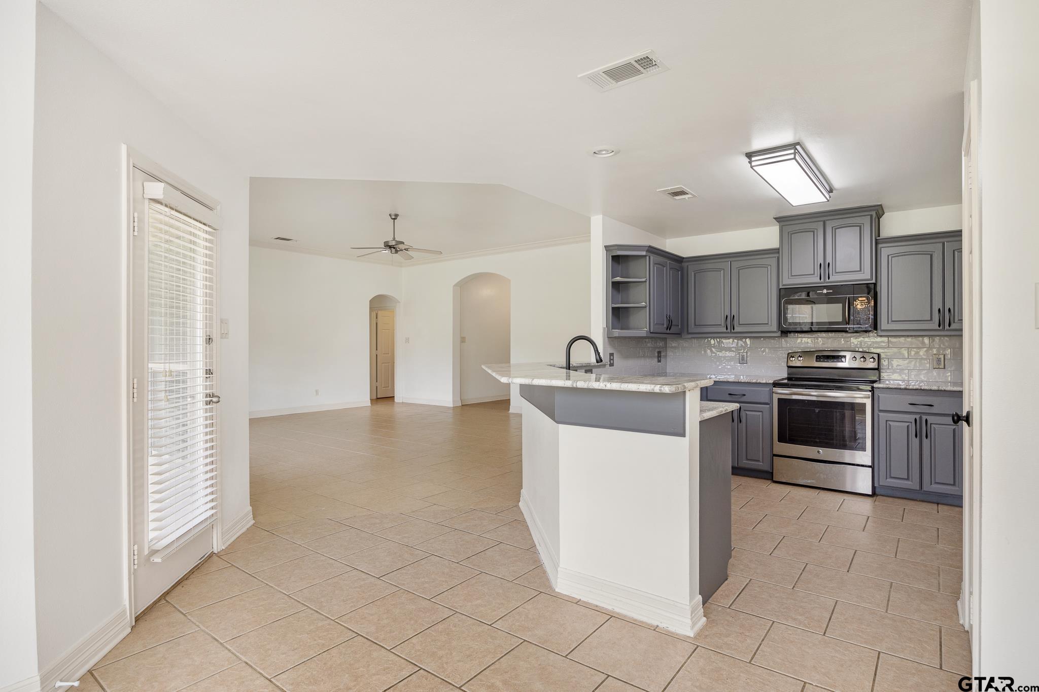 209 Cass Circle Tyler, TX 75703 - Photo 10 of 33 a kitchen with stainless steel appliances granite countertop a refrigerator sink and stove