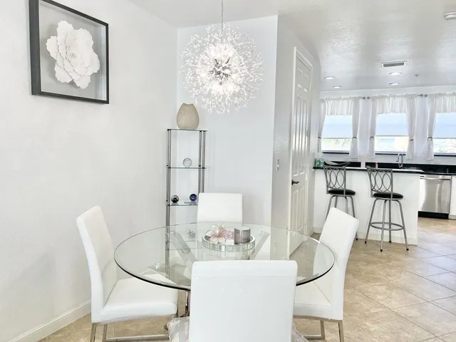 a living room with furniture a dining table and kitchen view