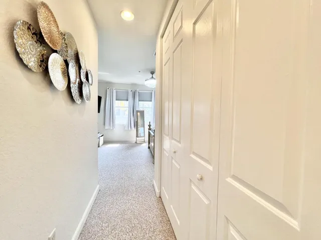 a view of a hallway with wooden floor and entryway