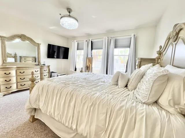 a bedroom with a large bed and a tv