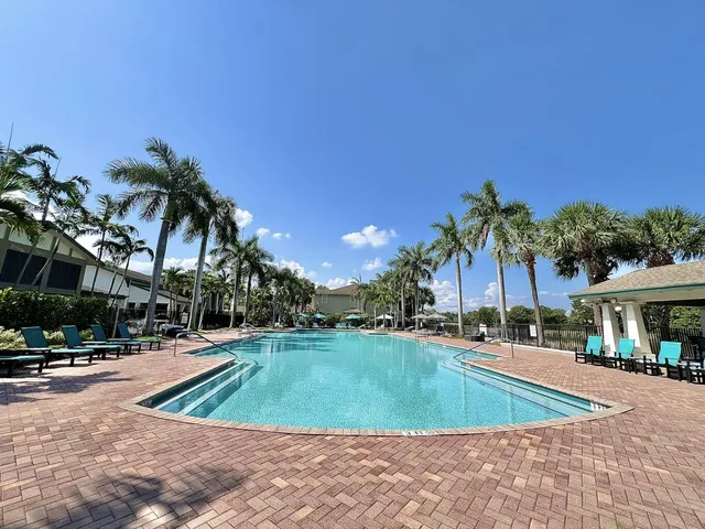 a view of a swimming pool and trees in the background