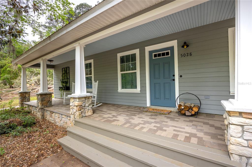 5028 Southwest 47th Street Gainesville, FL 32608 - Photo 11 of 49 a front view of a house with outdoor seating