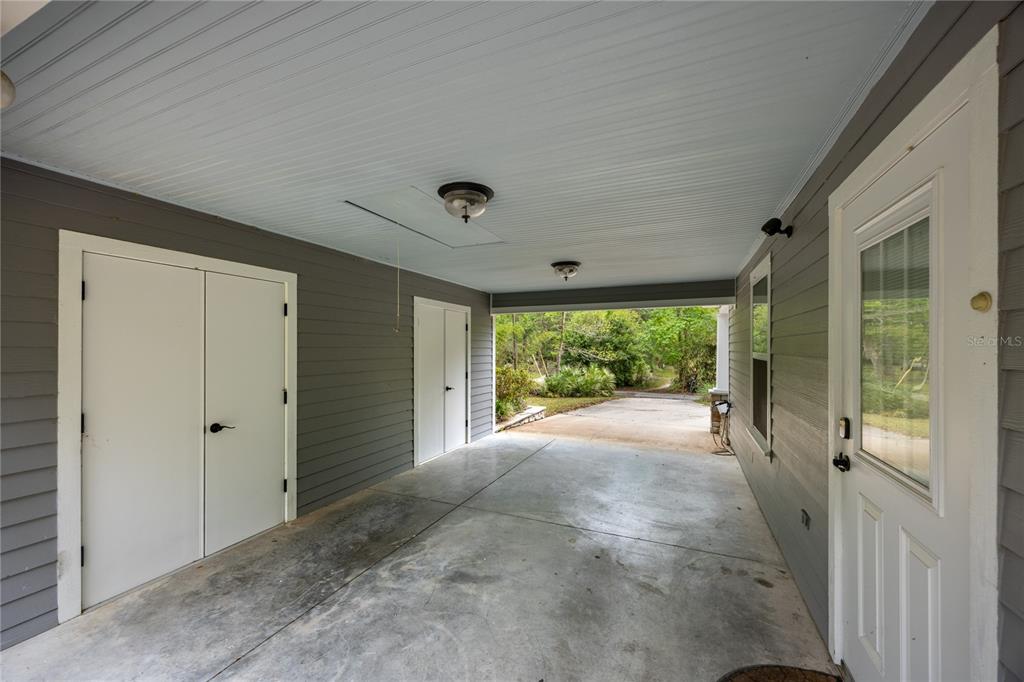 5028 Southwest 47th Street Gainesville, FL 32608 - Photo 13 of 49 a view of a porch with a floor to ceiling window and garden