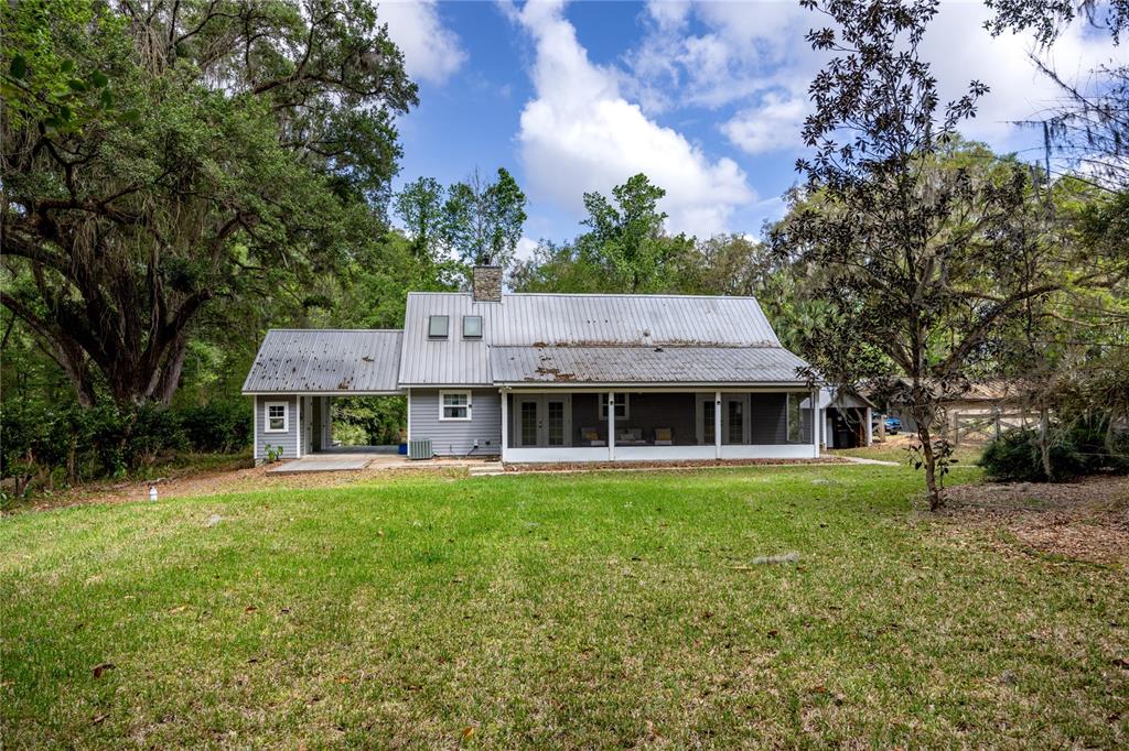 5028 Southwest 47th Street Gainesville, FL 32608 - Photo 22 of 49 a front view of a house with a garden