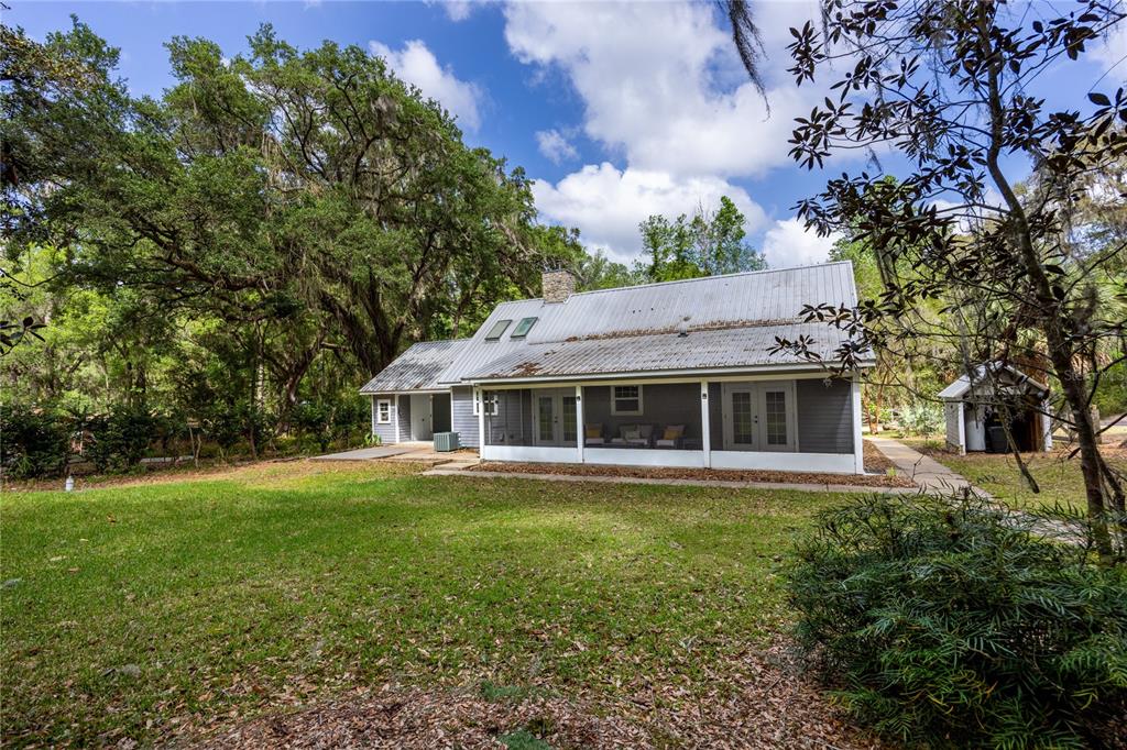 5028 Southwest 47th Street Gainesville, FL 32608 - Photo 23 of 49 a front view of a house with a garden