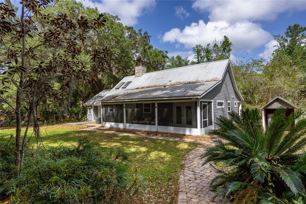 5028 Southwest 47th Street Gainesville, FL 32608 - Photo 24 of 49 a view of a house with garden and trees