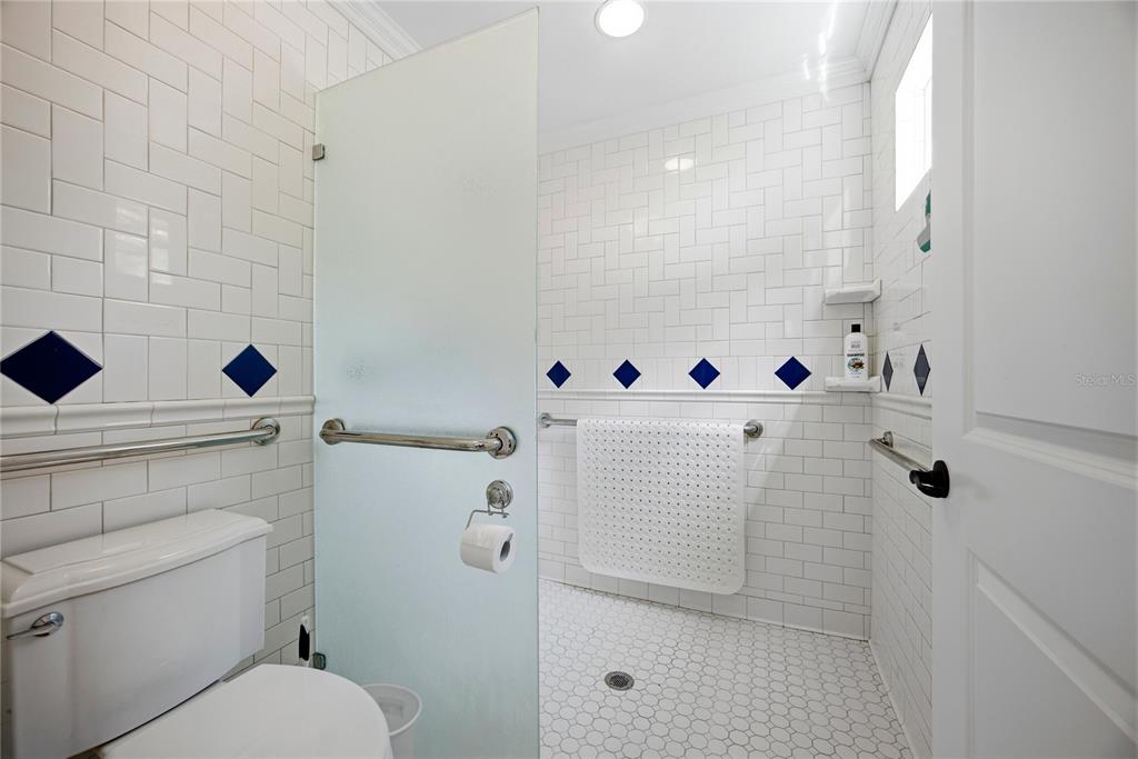 5028 Southwest 47th Street Gainesville, FL 32608 - Photo 39 of 49 a bathroom with a toilet and a shower