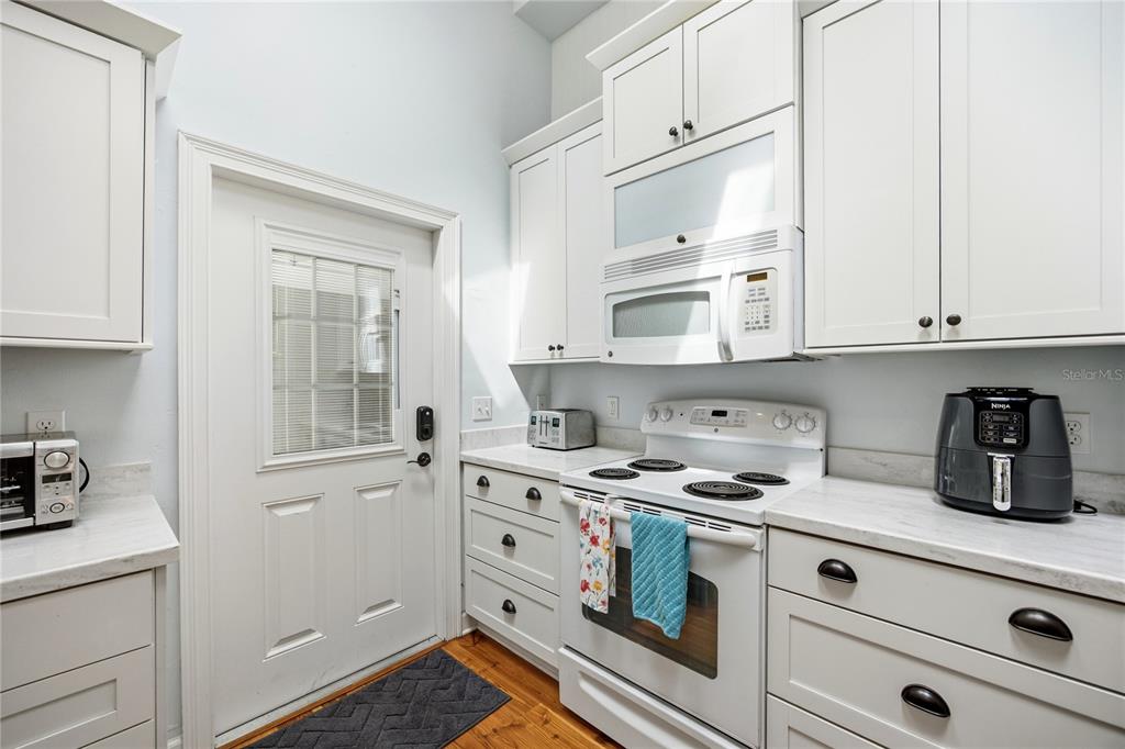 5028 Southwest 47th Street Gainesville, FL 32608 - Photo 45 of 49 a kitchen with stainless steel appliances white cabinets and a stove