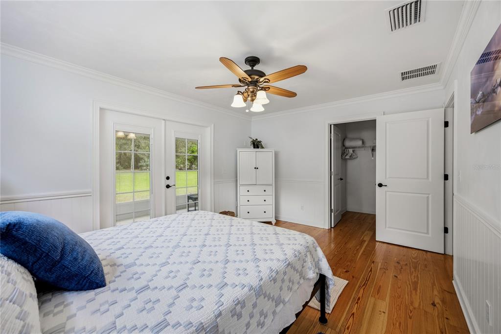 5028 Southwest 47th Street Gainesville, FL 32608 - Photo 49 of 49 a bedroom with a bed and a chandelier
