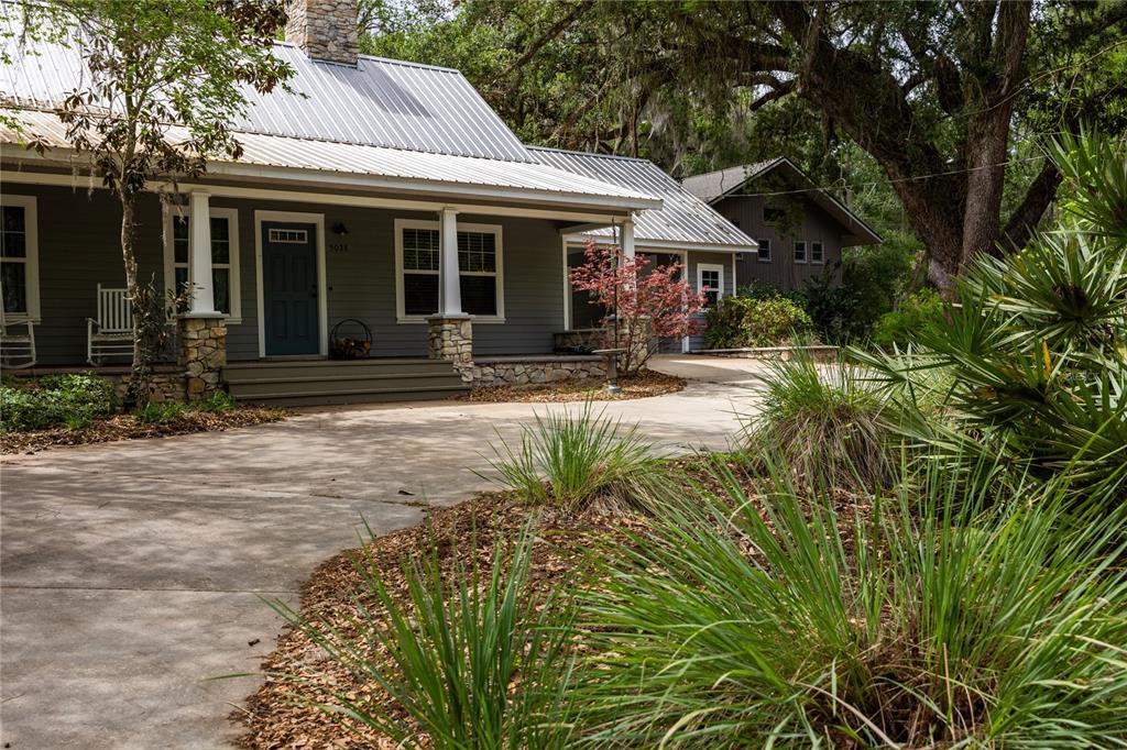 5028 Southwest 47th Street Gainesville, FL 32608 - Photo 5 of 49 a front view of a house with garden and porch