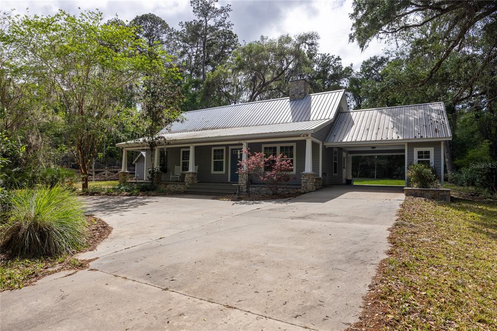 5028 Southwest 47th Street Gainesville, FL 32608 - Photo 6 of 49 a front view of a house with a garden