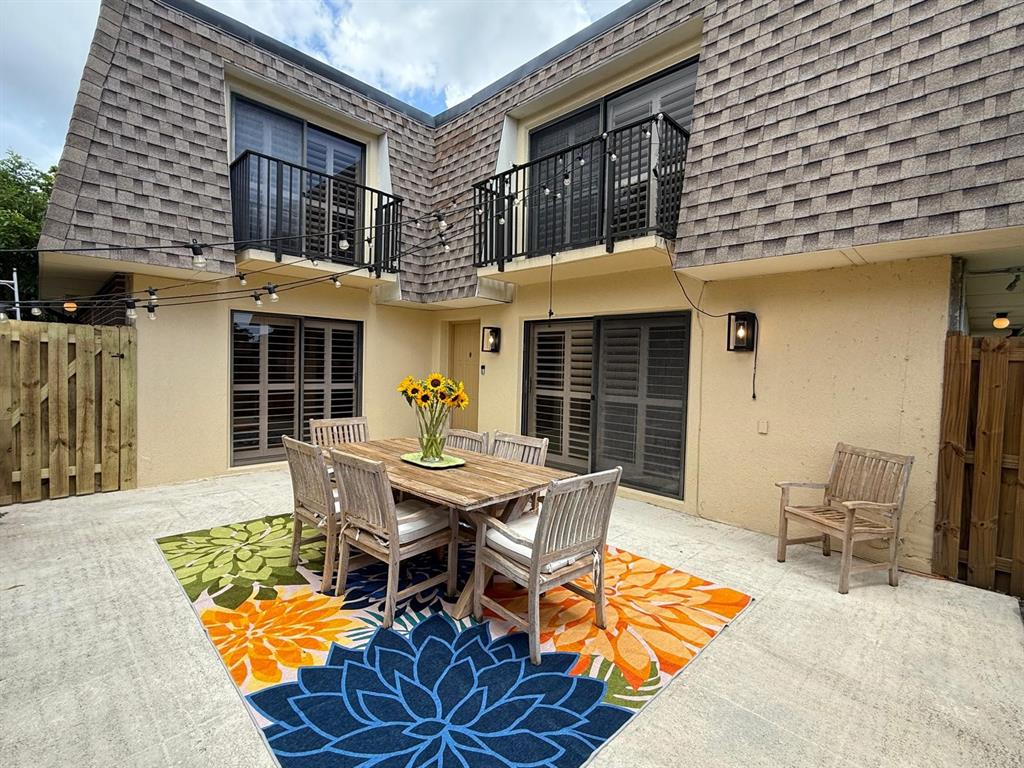 2911 Southwest 22nd Circle, Unit 37B Delray Beach, FL 33445 - Photo 1 of 51 a backyard of a house with table and chairs