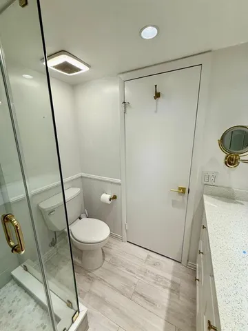 a bathroom with a toilet and a shower
