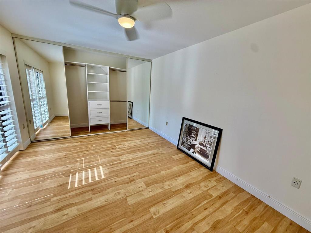 2911 Southwest 22nd Circle, Unit 37B Delray Beach, FL 33445 - Photo 32 of 51 a bedroom with a bed and a cabinets